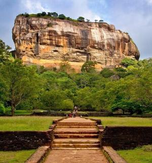 a staircase leading up to a large rock formation