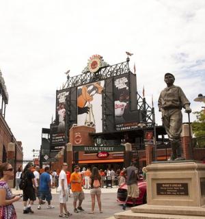a statue of a man standing in front of a street