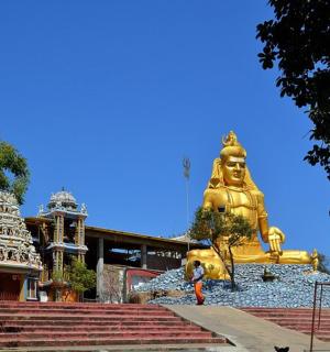 a large golden statue in front of a building