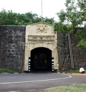 an entrance to a stone wall with a tunnel