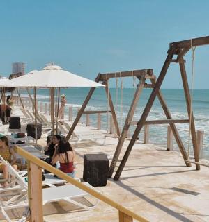 a group of people sitting on chairs at the beach