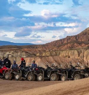 a group of people on atvs in the desert