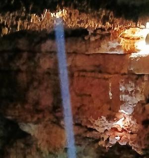 a reflection of a building in the water at night
