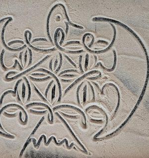 a drawing in the sand on the beach