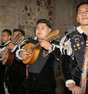 a group of men playing violins and guitar