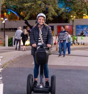 a woman riding a scooter on a street