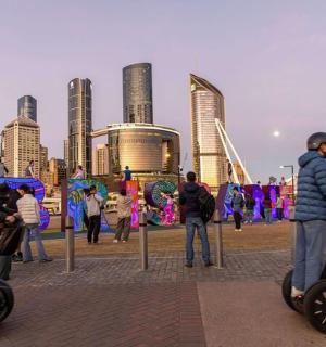 a group of people riding segways in front of a city