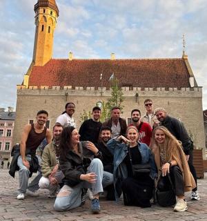 a group of people posing in front of a building