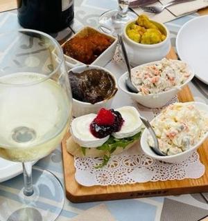 a table with a plate of food and a glass of wine