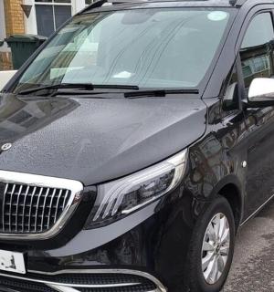 a black limousine parked in a parking lot