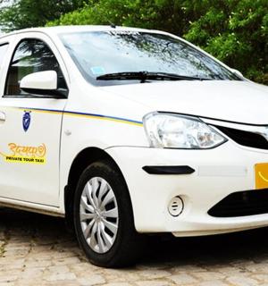 a white toyota aygo rental car parked on a street