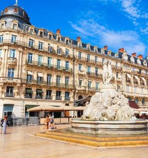 a building with a fountain in front of a building
