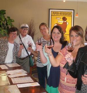 a group of people holding up wine glasses