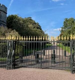 a wrought iron fence with a street light