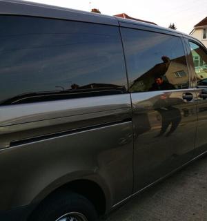 a silver van parked on the side of a street