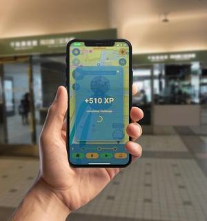 a person holding up a cell phone in a mall