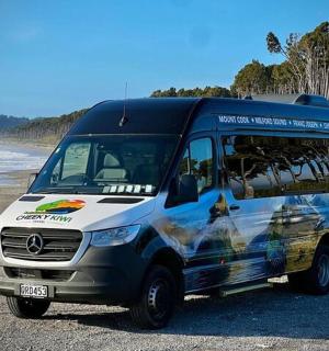 a blue and white van parked on the beach