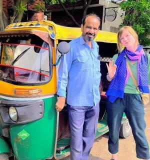 a man and a woman standing next to a golf cart
