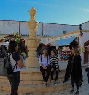 a group of people sitting on top of a fountain