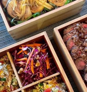 three containers of different types of food on a table
