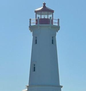 a lighthouse with a blue sky in the background