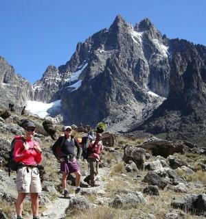 a group of people walking on a mountain trail