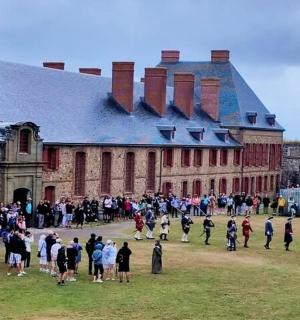 a large group of people standing in front of a building