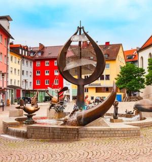 a fountain in the middle of a city with buildings