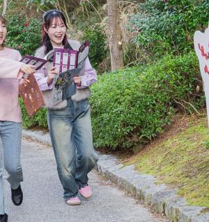 two women walking down a road with a sign
