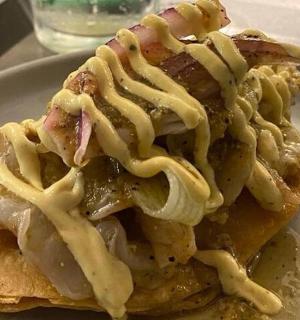 a piece of food with sauce on a plate