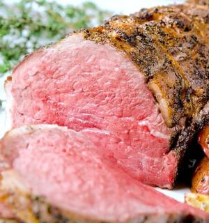 a piece of meat on a plate with vegetables