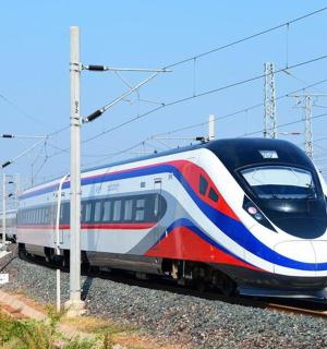 a red white and blue train on the tracks