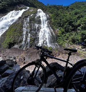 a bike parked in front of a waterfall