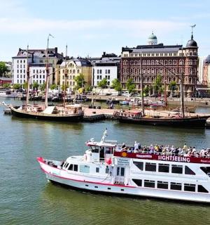 a boat in the water in a river with buildings