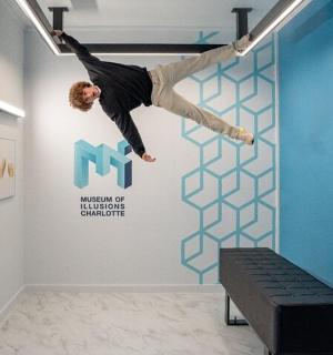 a man is jumping in the air over a wall