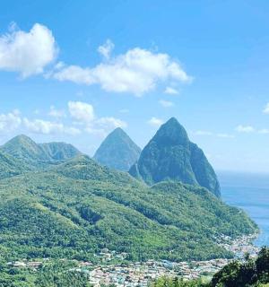 a view of mountains with the ocean and a city