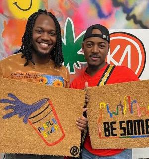 two men holding up cardboard signs with a birthday