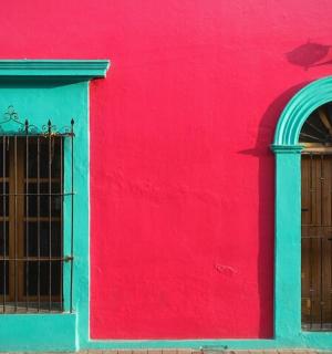 a red building with two windows and a door