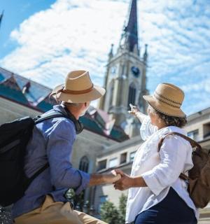 two people wearing hats standing in front of a building