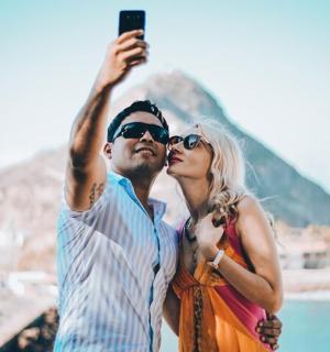 a man and a woman taking a picture with their cell phone