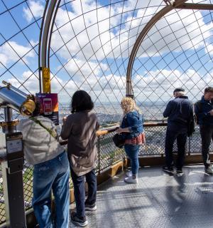 a group of people standing on the top of a observation deck