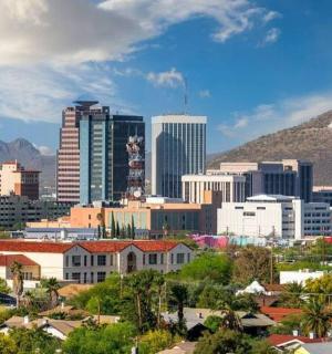 a city with buildings and a mountain in the background