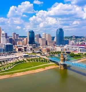 a bridge over a river with a city in the background