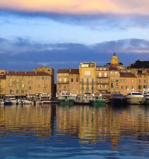 a group of boats docked in a harbor with buildings