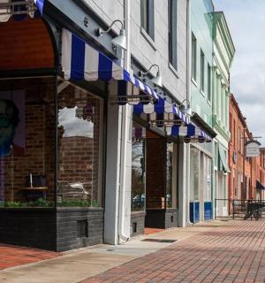 a street with a building with a face on the window