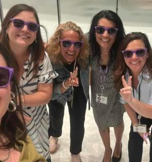 a group of women in sunglasses posing for a picture