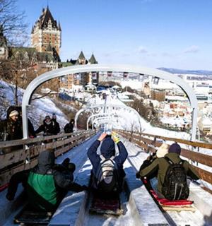 a group of people sitting on a bridge in the snow
