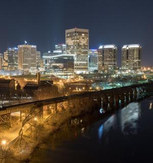 a view of a city at night with a bridge