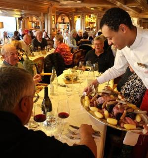 a chef serving a plate of food at a restaurant