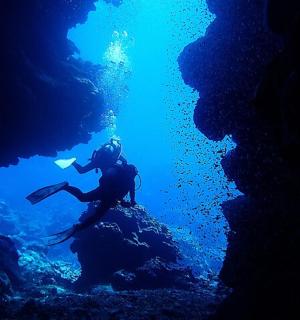 a person swimming in an underwater cave